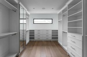 custom walk in closet with mirrored doors