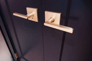 Weiser Halifax Lever in Satin Brass on Black Door